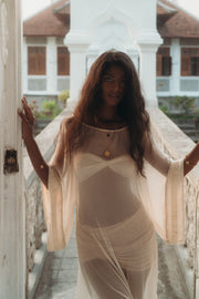 Woman wearing a sheer, flowing Sundari Kaftan in natural silk chiffon, embodying effortless bohemian elegance. This handmade sustainable fashion piece is perfect for Bali boho clothing lovers and slow fashion enthusiasts